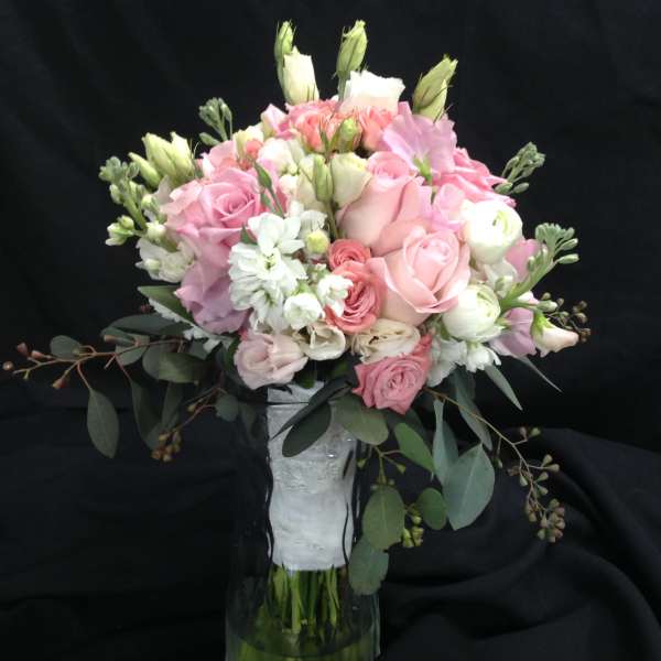 Pink and white bouquet in a clear glass vase
