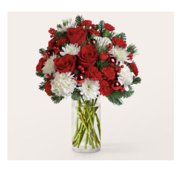 Red roses and white carnations in a clear glass vase
