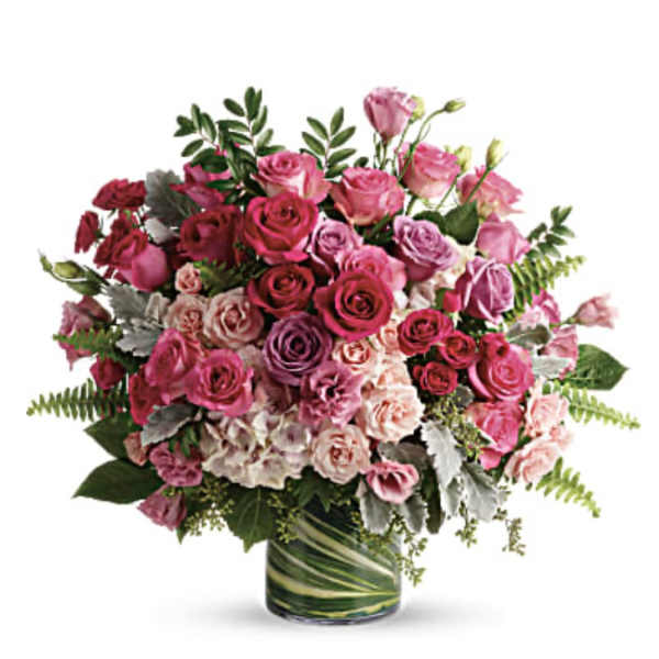 Pink and purple rose bouquet in a glass vase