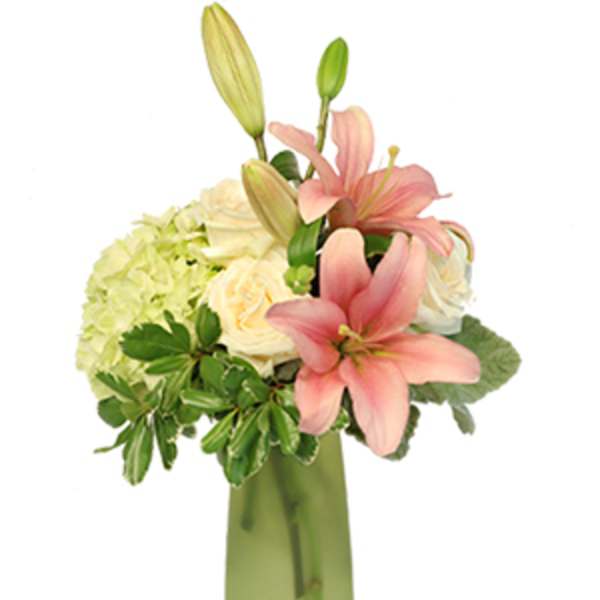 Pink lilies and cream roses in a green vase