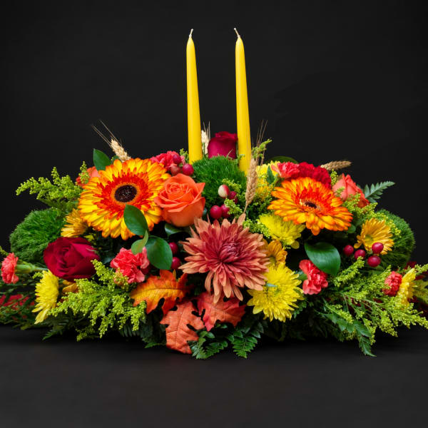 Autumn floral centerpiece with two yellow candles