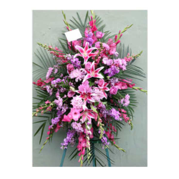 Pink and purple standing floral spray with lilies and carnations