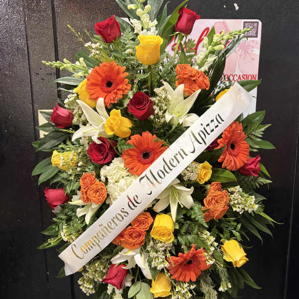 Standing floral spray with roses, lilies, and gerbera daisies