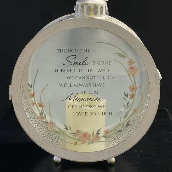 Round memorial lantern with a printed sympathy message and floral accents