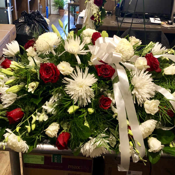 Large red and white floral spray with ribbon