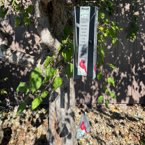 Cardinal memorial wind chime hanging from a tree