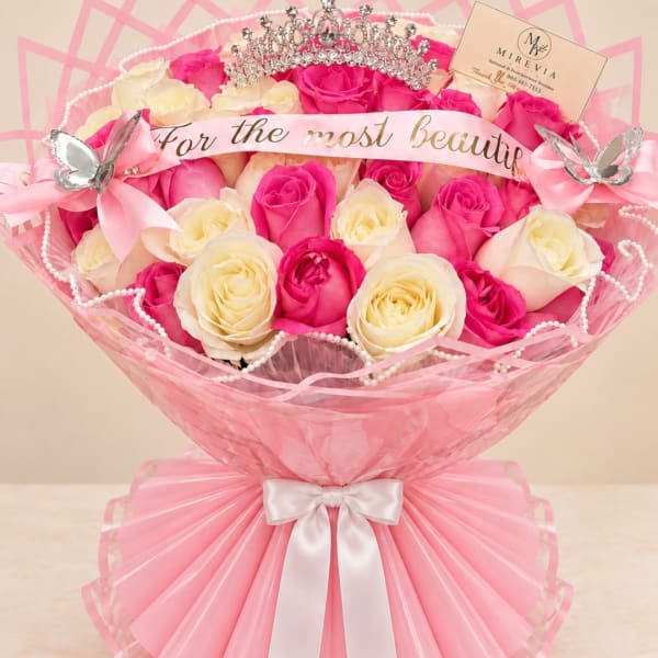 Pink and cream rose bouquet with ribbon, pearls, and a tiara topper