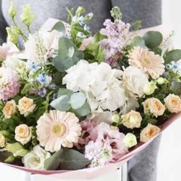 Pastel bouquet with white orchids, pink gerberas, and peach roses