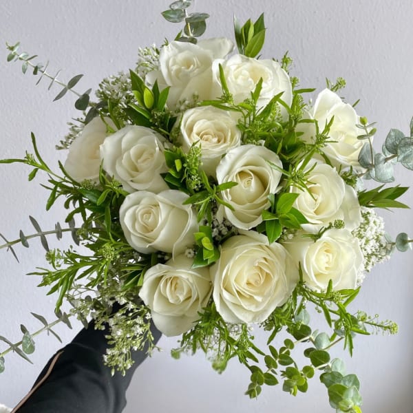 White rose bouquet with green foliage and eucalyptus