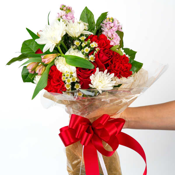 Bouquet of red and white flowers wrapped with a red ribbon