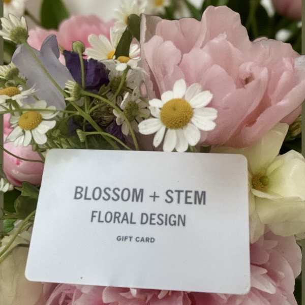 Pink and white flowers with a gift card in the center