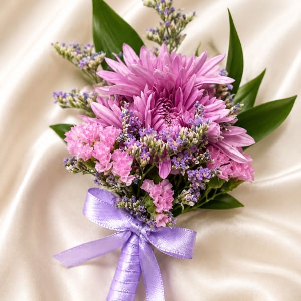 Pink and purple bouquet with a lavender ribbon on satin fabric