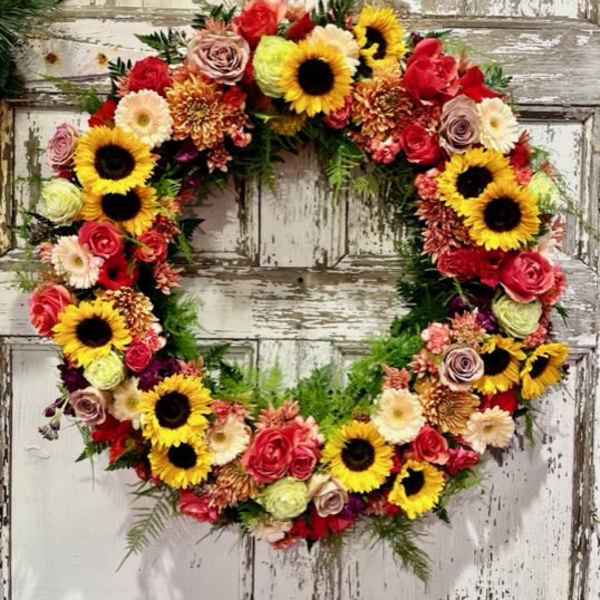 Heart-shaped floral wreath with sunflowers and roses