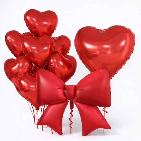 Cluster of red heart balloons with a large red bow balloon