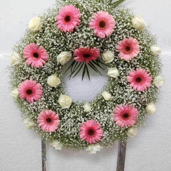 Pink gerbera daisy wreath with white roses and baby's breath