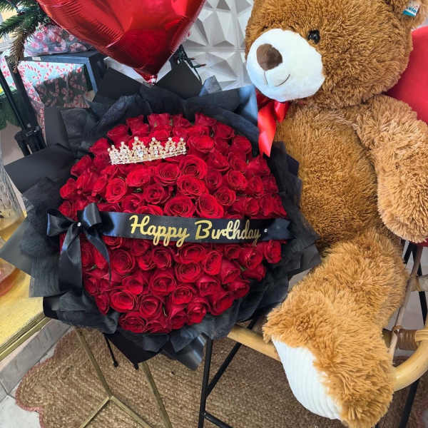 Red rose bouquet with a heart balloon and teddy bear