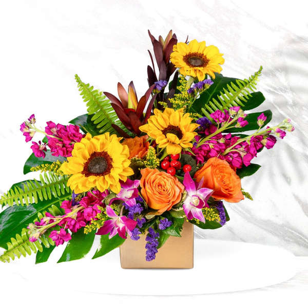 Bright mixed bouquet with sunflowers and orange roses in a square box