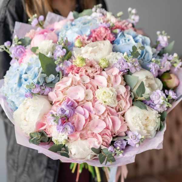 Pastel bouquet of hydrangeas, peonies, and small purple flowers