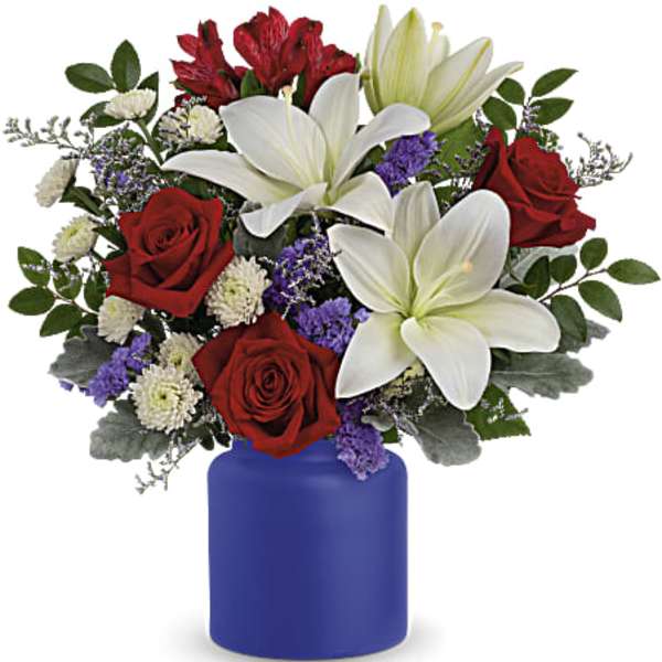 Red roses and white lilies in a blue vase