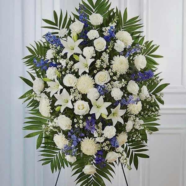 White and blue funeral spray on a standing easel