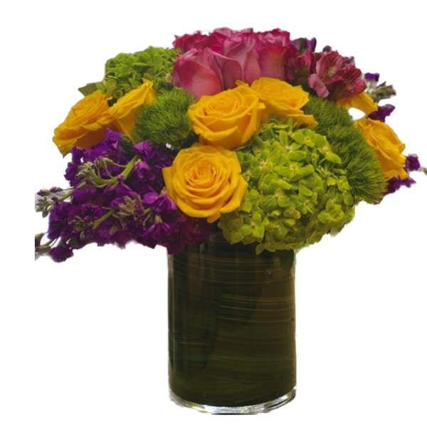Colorful bouquet of roses, hydrangeas, and purple flowers in a glass vase