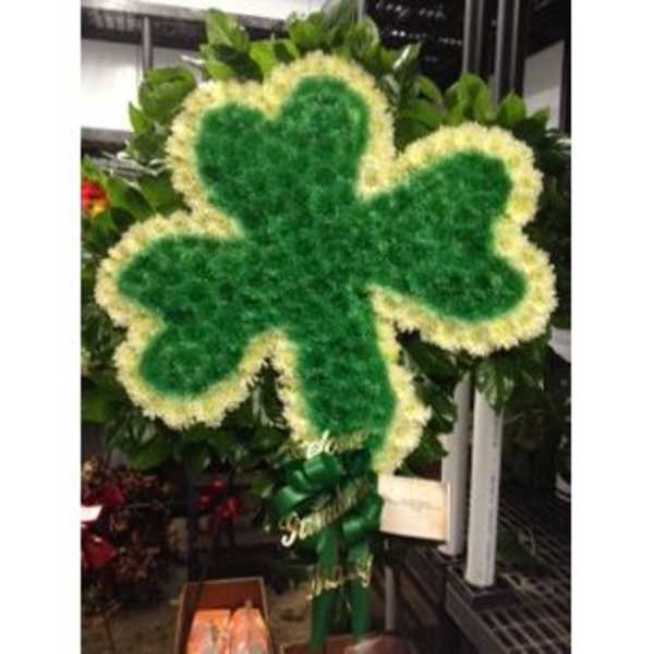 Shamrock-shaped floral wreath with green center and pale yellow edge