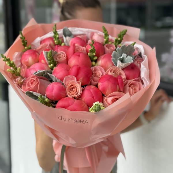 Pink tulip and rose bouquet wrapped in blush paper