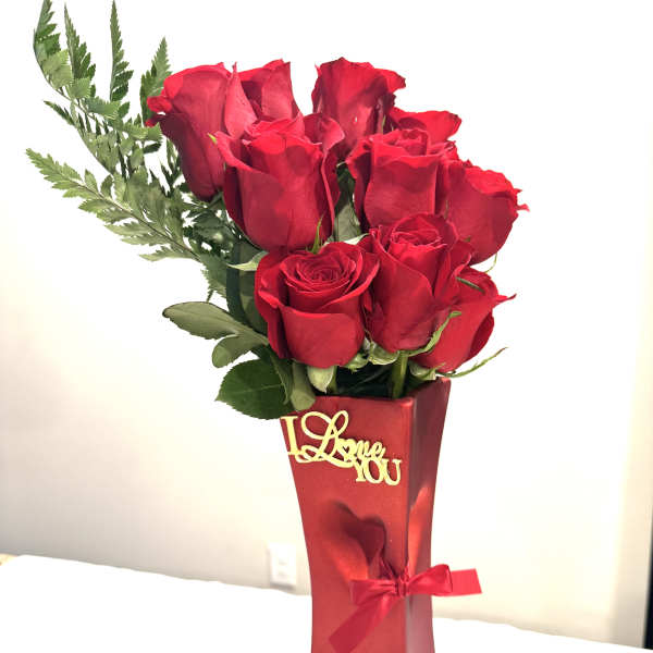 Red roses in a tall red gift box with a ribbon