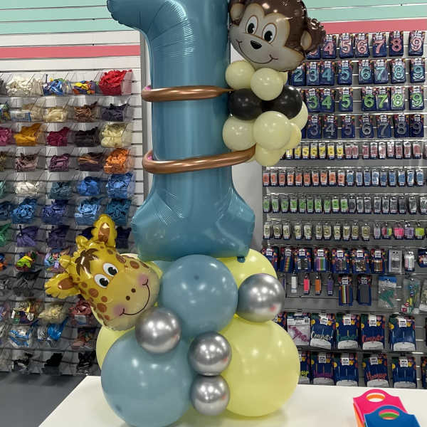 Balloon tower with a large blue number 1 and animal face balloons