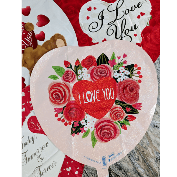 Heart-shaped Valentine balloons with roses and "I Love You" text