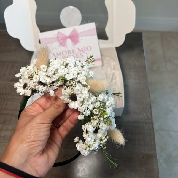 Small white floral crown with daisies and fluffy accents in a gift box