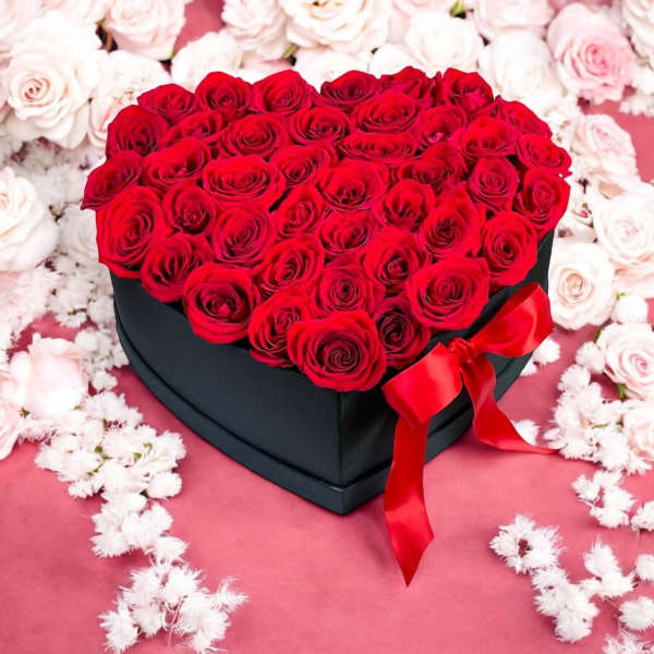 Heart-shaped box of red roses with a red ribbon