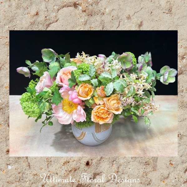 Mixed pastel floral arrangement in a round ceramic vase