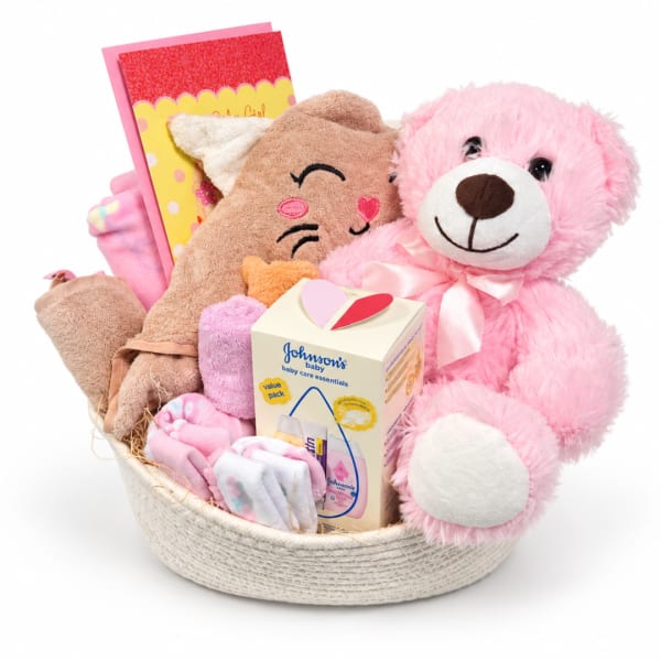 Gift basket with pink teddy bear, baby items, and a card