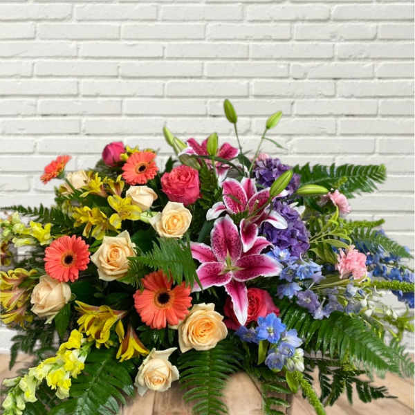 Colorful mixed flower arrangement with roses, lilies, and gerbera daisies