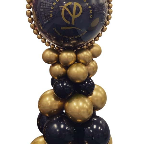 Gold and black balloon column with a large branded balloon topper