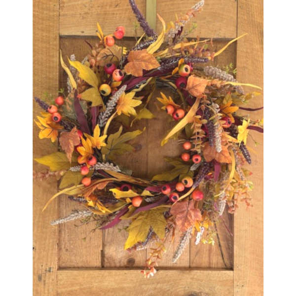Autumn wreath with berries and mixed foliage on a wooden door