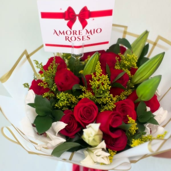 Bouquet of red and white roses with lilies and a gift card
