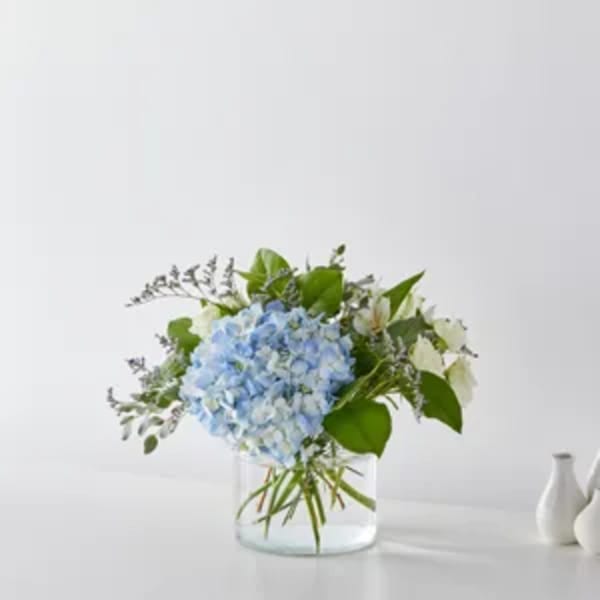 Blue hydrangea arrangement in a clear glass vase
