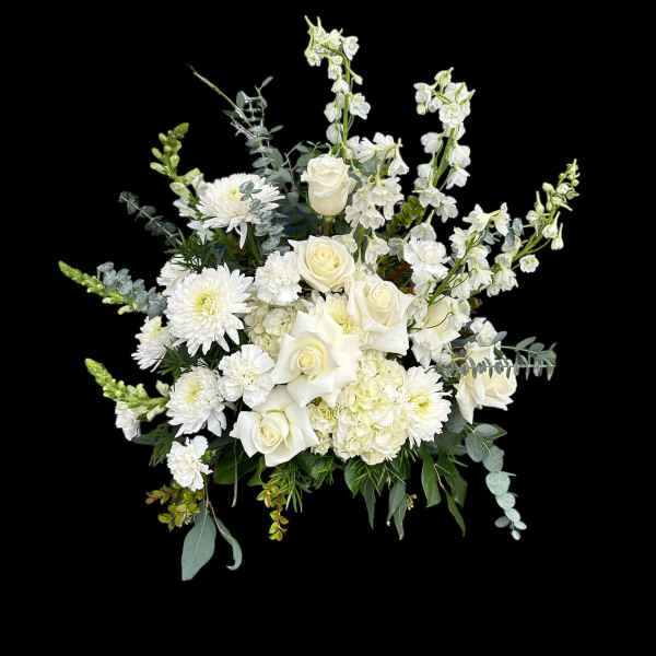 White roses and chrysanthemums arranged with tall white blooms