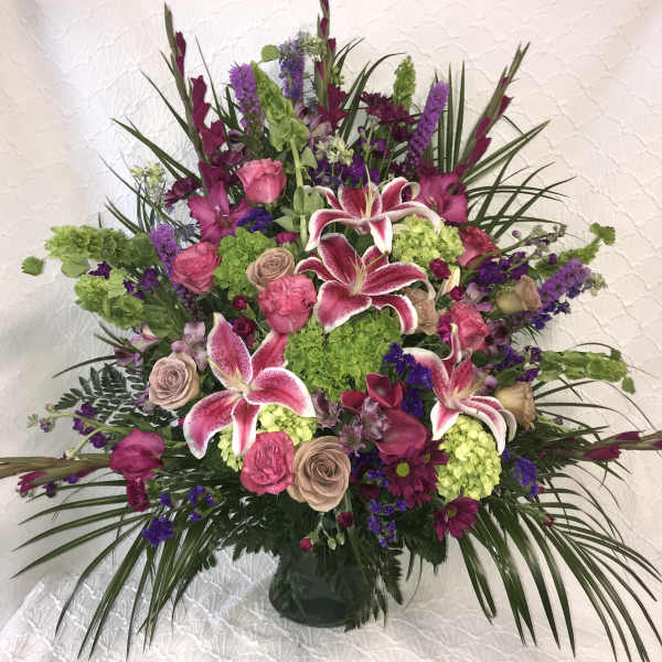 Large mixed bouquet with pink lilies and roses in a vase