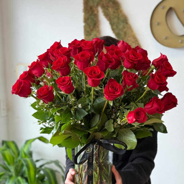 Large bouquet of red roses in a clear glass vase