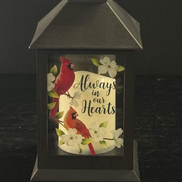 Black lantern with cardinals and flowers reading "Always in our Hearts"