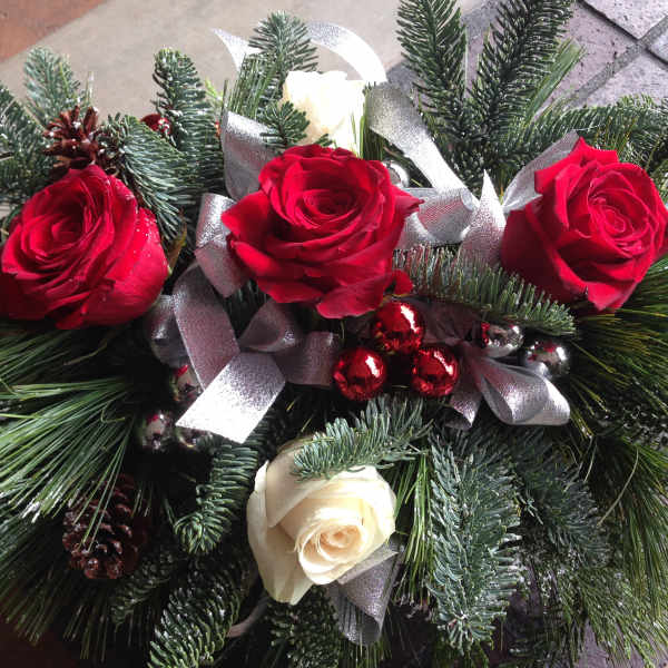 Red and white roses with pine branches and silver ribbon