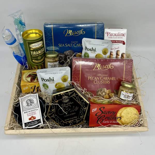 Gift basket with assorted snacks and candies in a wooden tray