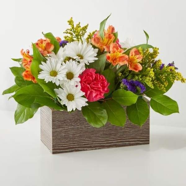 Mixed bouquet in a rectangular wooden box with daisies, carnations, and orange alstroemeria