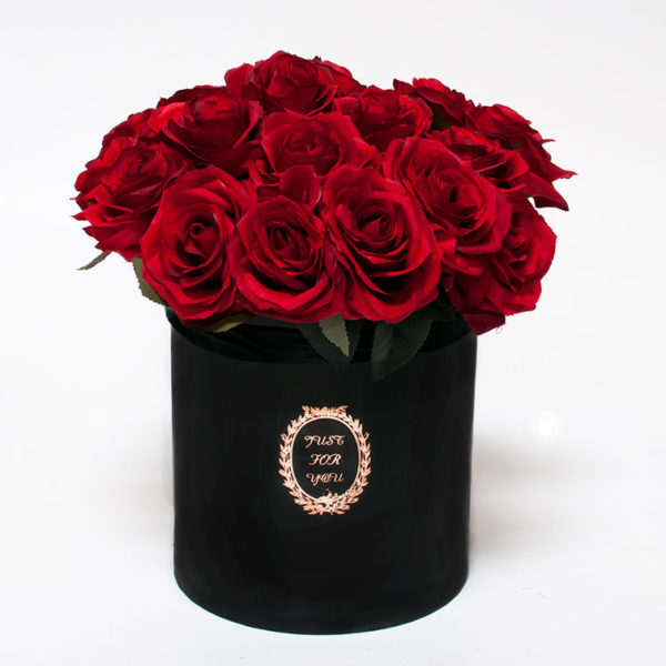Red roses arranged in a black cylindrical box