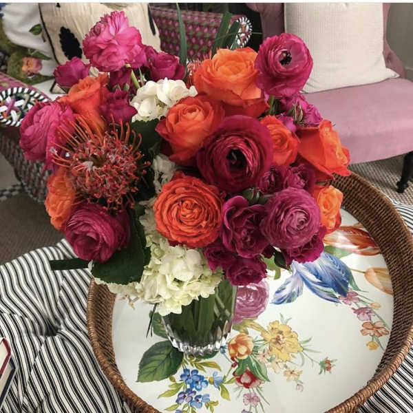 Bouquet of pink and orange flowers in a glass vase