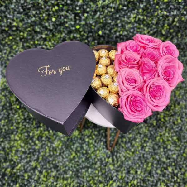 Heart-shaped box with pink roses and gold chocolates