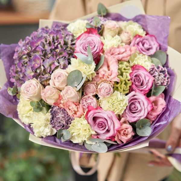 Bouquet of pink and purple roses with hydrangeas and carnations